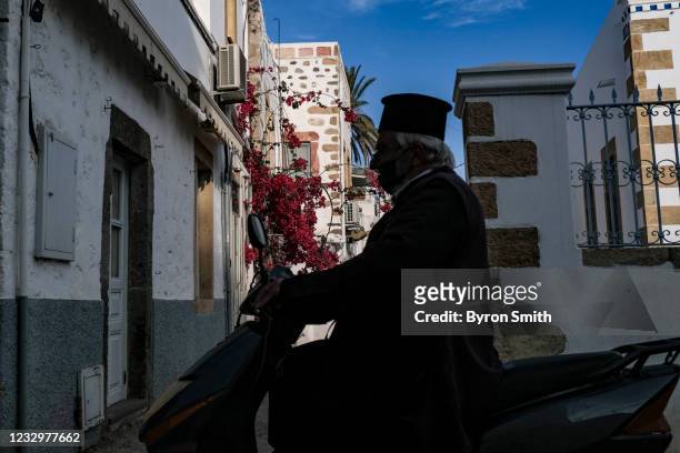 Locals from the Greek island of Patmos make their way around the Skala village on May 17, 2021 in Patmos, Greece. Restrictive travel rules due to the...