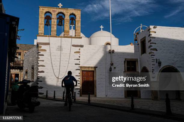 Locals from the Greek island of Patmos make their way around the Skala village on May 17, 2021 in Patmos, Greece. Restrictive travel rules due to the...