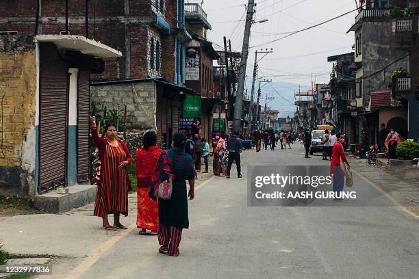 Residents gather outdoors along a road after a 5,8 magnitude earthquake hit Besisahar of Lamjung district, some 200 Km west of Nepal's capital...