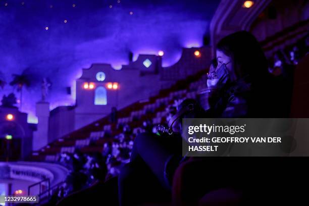 Spectators wait for the start of a projection of "Demon Slayer - Kimetsu no Yaiba" animated film at the Grand Rex cinema theatre in Paris on May 19...