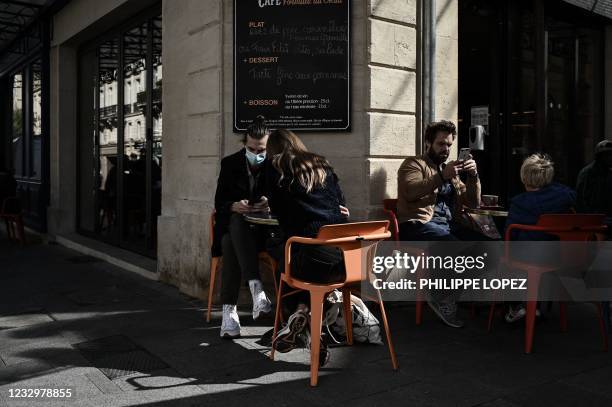 Customers sit at the outdoor terrasse of a cafe restaurant in Bordeaux on May 19 as cafes, restaurants and other businesses re-opened after closures...