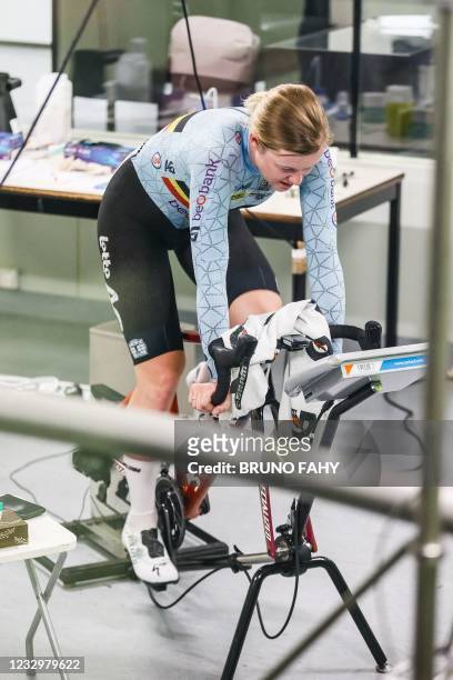 Belgian track cyclist Jolien D'hoore rides a static cycle as she takes part in a training session in Leuven on May 19 testing specialist clothing in...