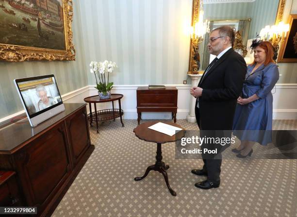 Queen Elizabeth II appears on a screen by videolink from Windsor Castle, where she is in residence, during a virtual audience to receive Javier...