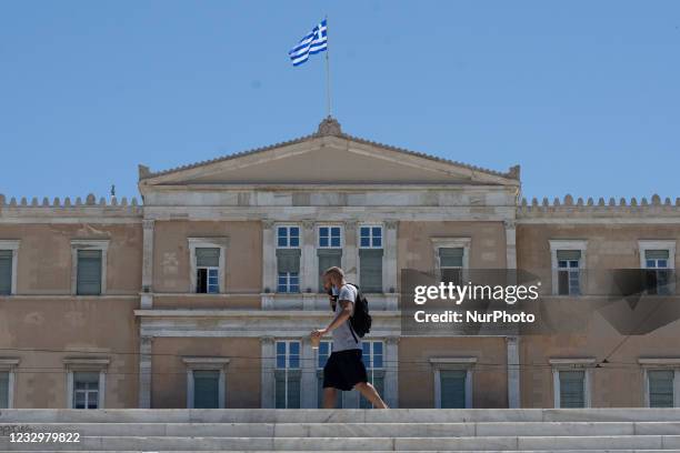 Man seen walking front of the Greek Parliament wearing protected mask at the center of Athens, Greece on May 19, 2021.