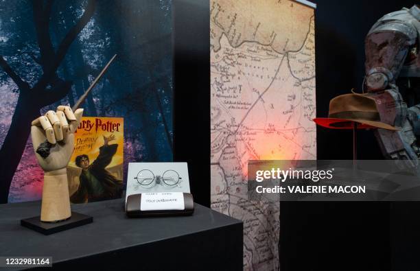 Harry Potter's wand and eyeglasses and a copy of "Harry Potter and the Deathly Hallows" are exhibited next to Harrison Ford's Indiana Jones' fedora...