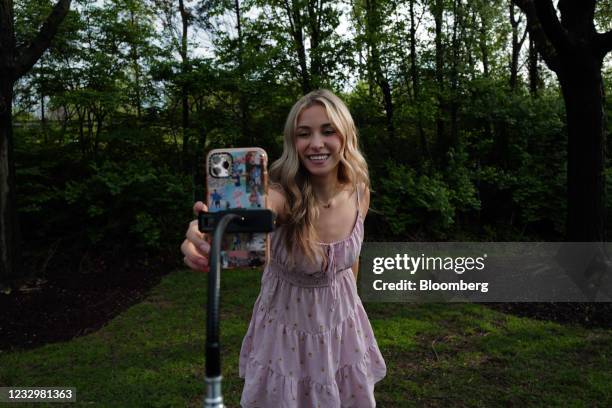 Katie Feeney, an 18-year-old TikTok creator, sets up a smartphone on a tripod at Rio Park in Gaithersburg, Maryland, U.S., on Thursday, April 15,...