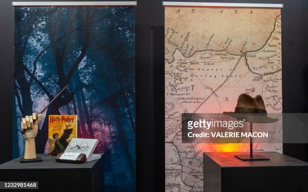 Harry Potter's wand and eyeglasses and a copy of "Harry Potter and the Deathly Hallows" are exhibited next to Harrison Ford's Indiana Jones' fedora...