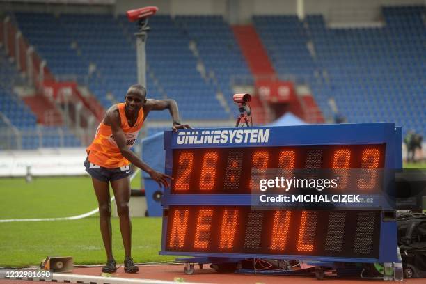 Jacob Kiplimo of Uganda poses next to his new World Lead time after the men's 10000m race during the IAAF Golden Spike 2021 Athletics meeting in...