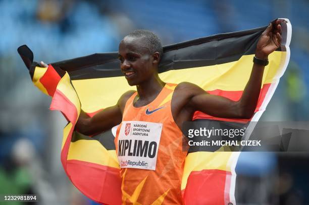 Jacob Kiplimo of Uganda celebrates with his country's flag after the men's 10000m race during the IAAF Golden Spike 2021 Athletics meeting in...