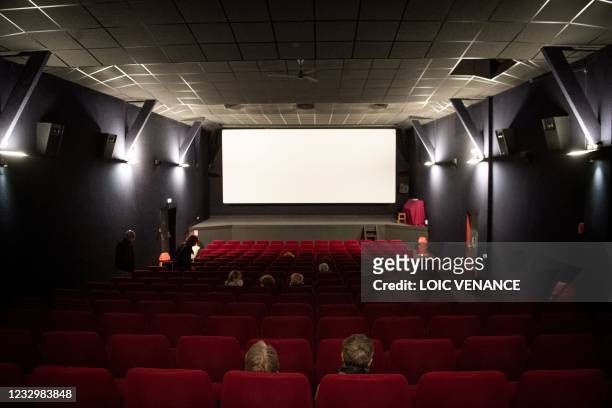 People sit in a movie theatre in Le Palais in the island of Belle-Ile-en-Mer, on May 19 as restaurant, bar terraces, museum and cinema reopen today,...