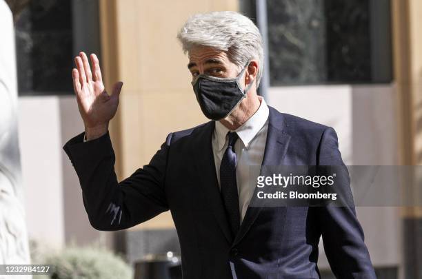 Craig Federighi, senior vice president of Software Engineering for Apple Inc., waves while arriving at U.S. District court in Oakland, California,...