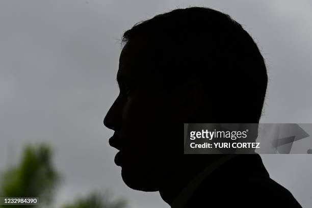 View of the silhouette of Venezuelan opposition leader Juan Guaido as he speaks during a press conference at the Morichal Park of the Prados del Este...
