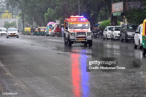 An ambulance on the road while it rains near LNJP Hospital on May 19, 2021 in New Delhi, India. India Meteorological Department scientists said Delhi...