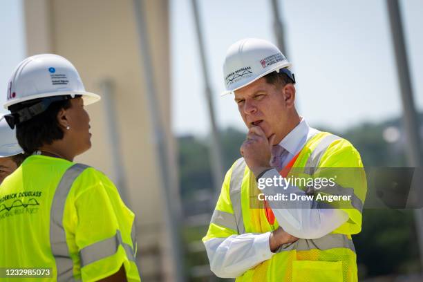 Washington, DC Mayor Muriel Bowser talks with Secretary of Labor Marty Walsh as they tour the construction site atop the new Frederick Douglass...