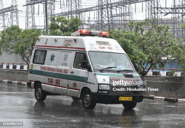 An ambulance during the rain at Geeta Colony, on May 19, 2021 in New Delhi, India. India Meteorological Department scientists said Delhi is also...