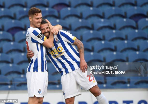 Porto's Spanish forward Toni Martinez celebrates with teammate FC Porto's Portuguese midfielder Sergio Oliveira after scoring a goal during the...