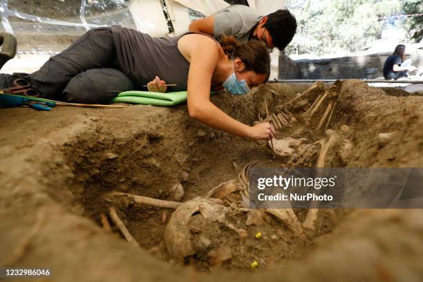 Forensic archaeologists work cleaning and exhuming some bodies found in a common grave on May 19, 2021 in Viznar , Spain. An interdisciplinary team...