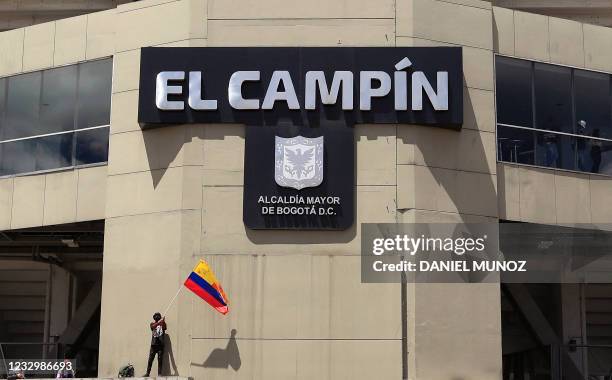 Man holds a Colombian flag during a protest against Colombia hosting the Copa America football tournament outside El Campin Stadium in Bogota, on May...