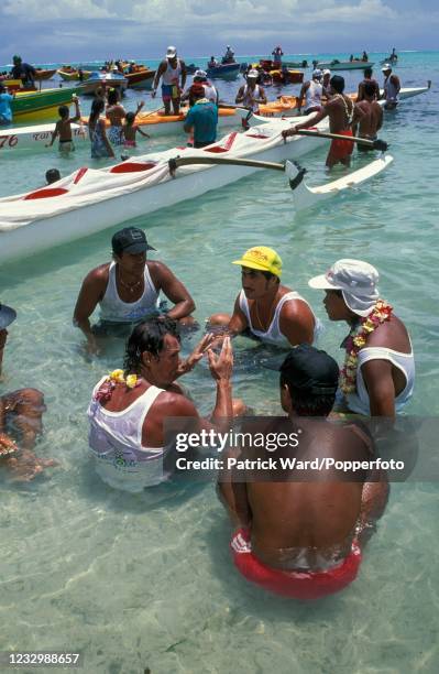 Competitors cooling off on Matira Beach at the climax of a 120-kilometre inter-island canoe race on the island of Bora Bora, French Polynesia, circa...