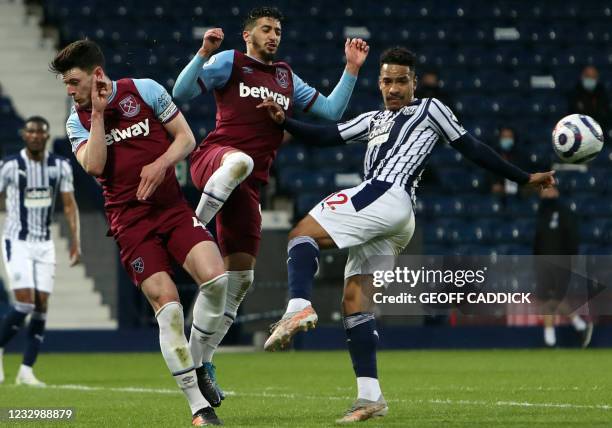 West Ham United's English midfielder Declan Rice and West Ham United's Spanish midfielder Pablo Fornals challenge West Bromwich Albion's Brazilian...