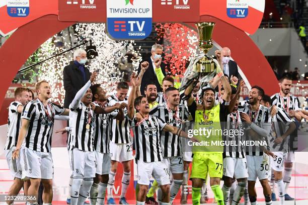 Juventus' Italian goalkeeper Gianluigi Buffon holds the winner's trophy as Juventus players celebrate winning the final of the Italian Cup football...