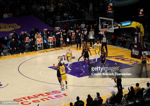 LeBron James of the Los Angeles Lakers scores the game winning three point basket against Stephen Curry of the Golden State Warriors in the closing...