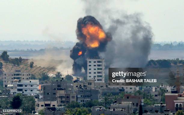 Ball of fire erupts from a building in Gaza City's Rimal residential district on May 20 during Israeli bombardment on the Hamas-controlled enclave. -...