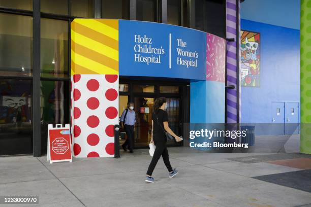 Pedestrian passes in front of Holtz Children's Hospital in Miami, Florida, U.S., on Wednesday, May 18, 2021. Coronavirus cases in the U.S. Increased...