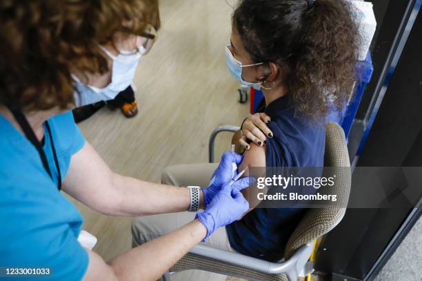 Healthcare worker administers a dose of the Pfizer-BioNTech Covid-19 vaccine to a teenager at Holtz Children's Hospital in Miami, Florida, U.S., on...
