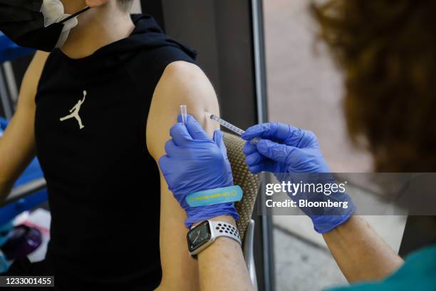 Healthcare worker administers a dose of the Pfizer-BioNTech Covid-19 vaccine to a teenager at Holtz Children's Hospital in Miami, Florida, U.S., on...