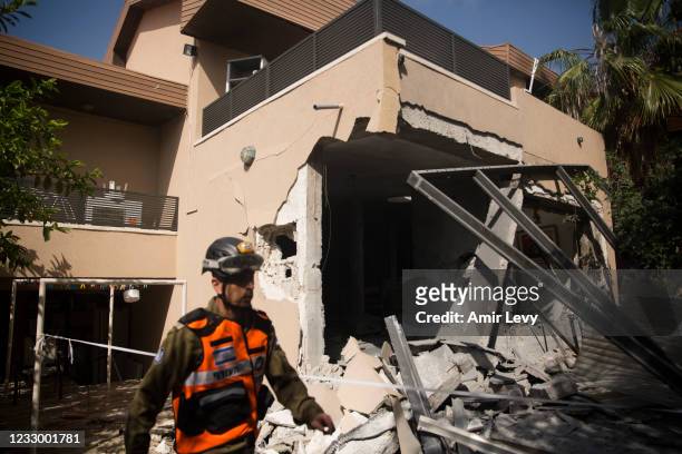Rescue team soldier work at the house where a rocket fired from the Gaza Strip hit Sigal's house on May 20, 2021 in Ashkelon, Israel. In a press...