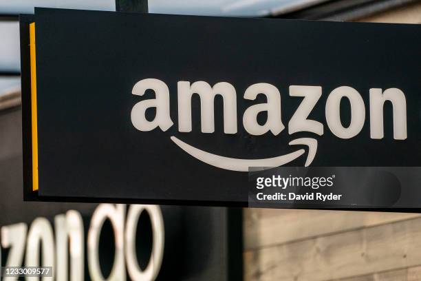 Sign is seen outside of an Amazon Go store at the Amazon.com Inc. Headquarters on May 20, 2021 in Seattle, Washington. Five women employees sued...