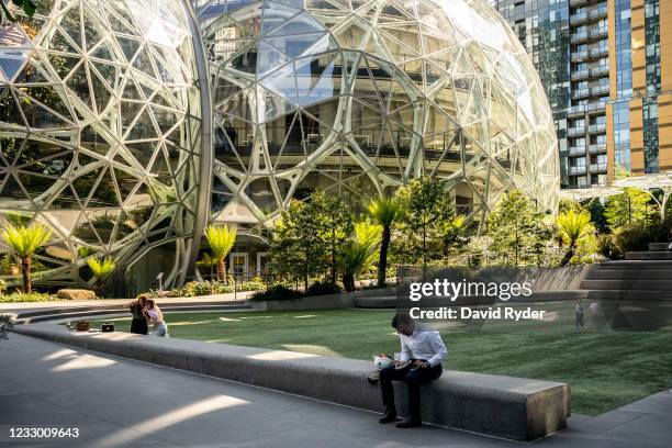 People use a common space outside of The Spheres at the Amazon.com Inc. Headquarters on May 20, 2021 in Seattle, Washington. Five women employees...