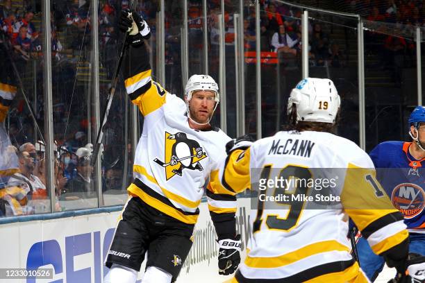 Jeff Carter of the Pittsburgh Penguins is congratulated by Jared McCann after scoring a goal against the New York Islanders during the second period...