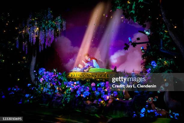 Magical forest scene shows Prince Charming delivering True Loves kiss, awakening Snow White from the Evil Queens spell, on Snow Whites Enchanted Wish...