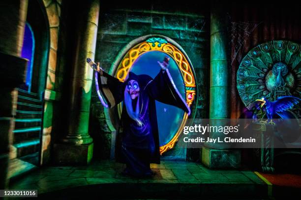 The Evil Queen transforms into an old lady who will give Snow White a poisoned apple, on Snow Whites Enchanted Wish ride at the Disneyland Resort in...