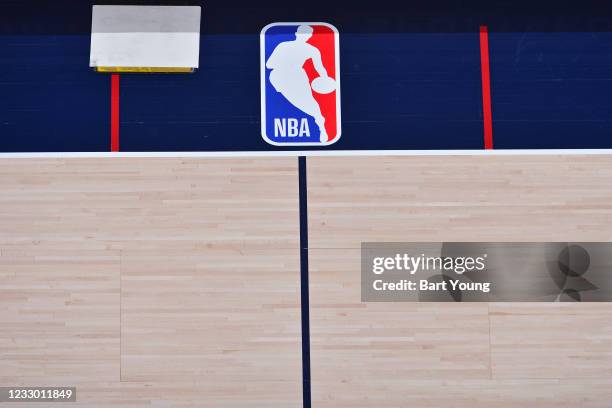 The NBA logo pictured on the court on April 6, 2021 at the Ball Arena in Denver, Colorado. NOTE TO USER: User expressly acknowledges and agrees that,...