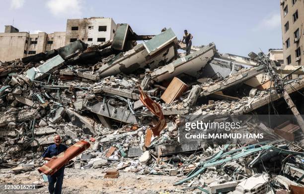 Man salvages items from the Al-Jalaa Tower in Gaza City, a building that hosted the offices of the Associated Press news agancey as well as the...