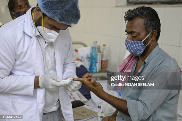 Doctor examines a patient who recovered from Covid-19 coronavirus and now infected with Black Fungus, a deadly fungal infection at a ward of a...