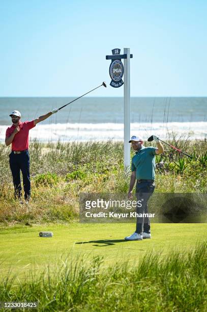 Branden Grace of South Africa and Adam Hadwin of Canada react fore left to Graces shot from the 18th tee during the first round of the PGA...