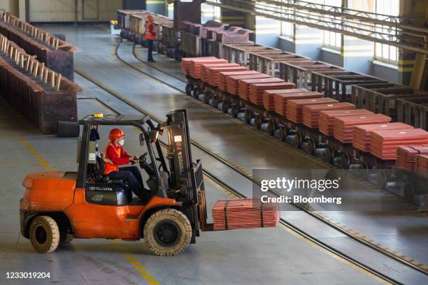 Worker uses a forklift truck to transport newly-made copper cathode sheets ahead of shipment from the electrolysis shop at the Uralelectromed Copper...