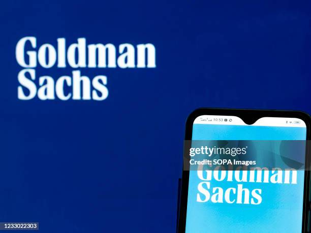 In this photo illustration, a Goldman Sachs Group logo seen displayed on a smartphone and in the background.