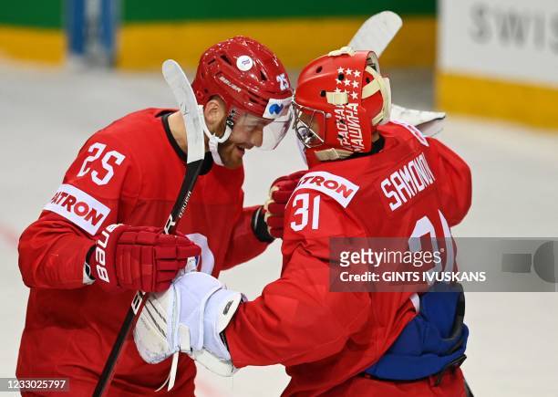 Russia's forward Mikhail Grigorenko celebrates scoring the game-winning goal with Russia's goalkeeper Alexander Samonov during the IIHF Men's Ice...