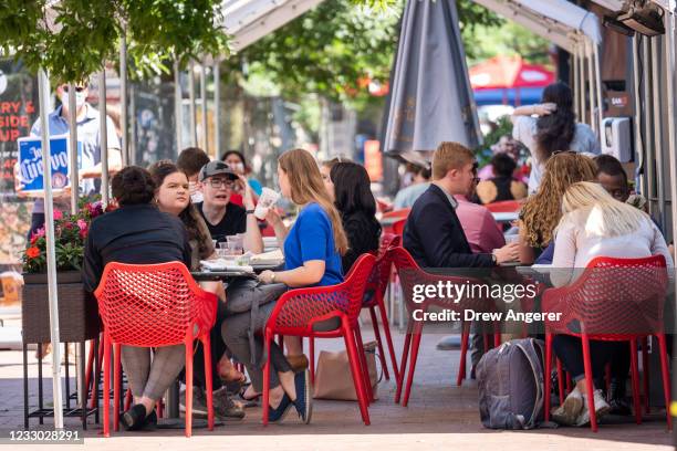 People eat outside during the lunch hour at a restaurant on Pennsylvania Avenue in the Capitol Hill neighborhood on May 21, 2021 in Washington, DC....