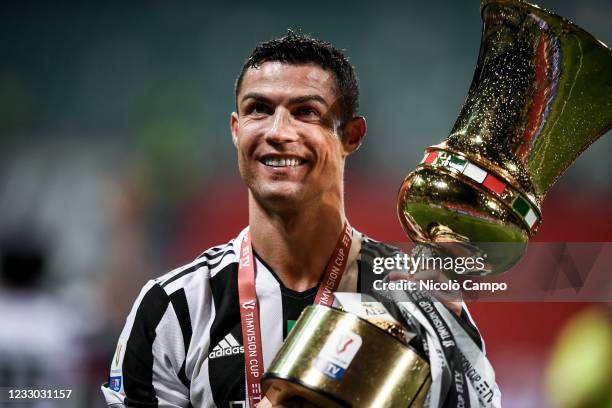 Cristiano Ronaldo of Juventus FC celebrates with the trophy during the award ceremony after the TIMVISION Cup final football match between Atalanta...