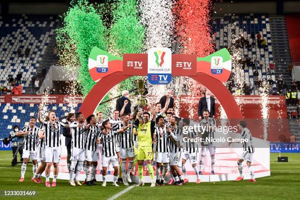 Gianluigi Buffon of Juventus FC lifts the trophy as players of Juventus FC celebrate the victory during the award ceremony after the TIMVISION Cup...