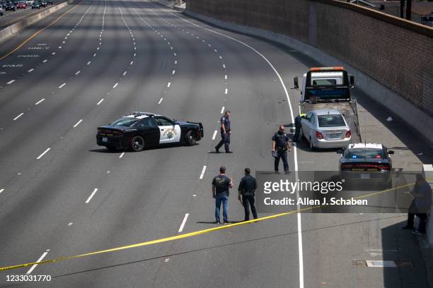 Crime scene investigators investigate the scene while the California Highway Patrol secures the northbound lanes of the 55 Freeway at Chapman Avenue...