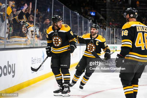 David Pastrnak of the Boston Bruins reacts after scoring in the third period of Game Four of the First Round of the 2021 Stanley Cup Playoffs against...