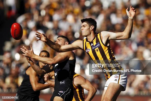 Ned Reeves of the Hawks and Marc Pittonet of the Blues compete for the ball during the 2021 AFL Round 10 match between the Carlton Blues and the...