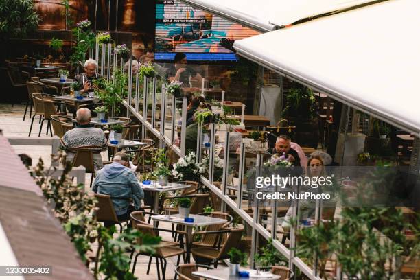People enjoys lunch inside an outdoor restaurant in Duesseldorf, Germany on May 21, 2021 as Duesseldorf reopens the outdoor dinning to easing of...